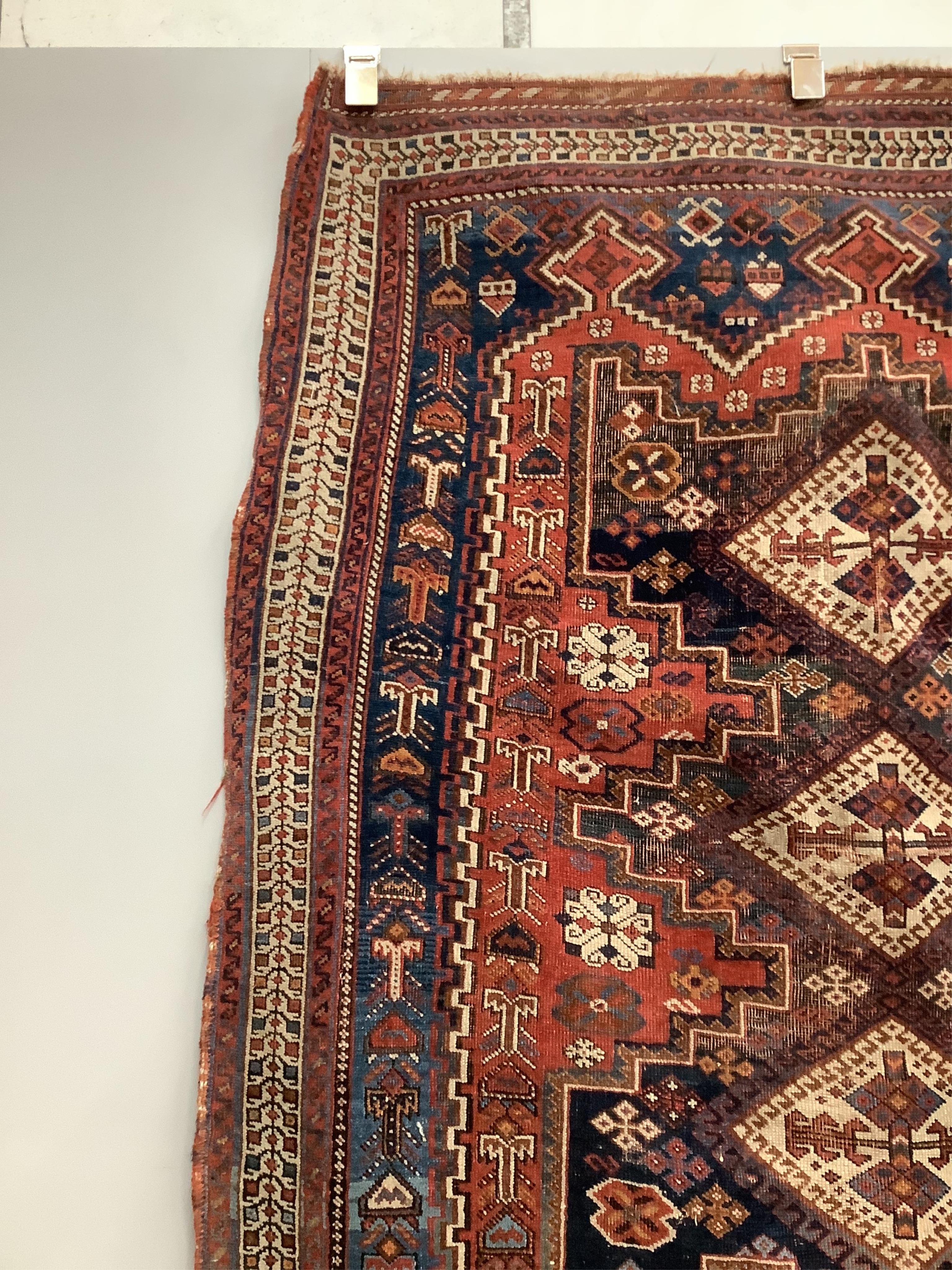 A Caucasian red ground rug, 150 x 118cm. Condition - worn in centre and a little faded, further wear around the edges